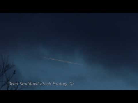 NM133 Jet Contrail In Clouds 4k 24p