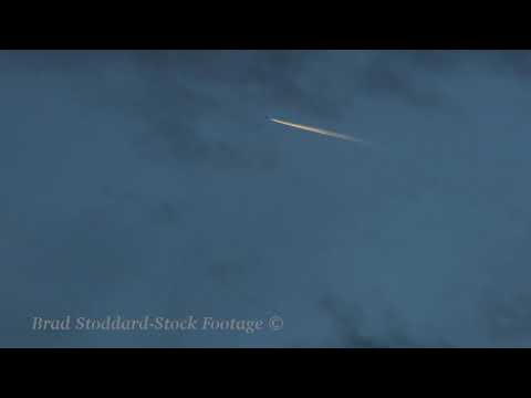 NM134 Jet Contrail In Clouds 4k 24p