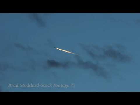 NM135 Jet Contrail In Clouds 4k 24p