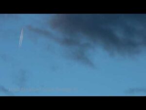 NM136 Jet Contrail In Clouds 4k 24p